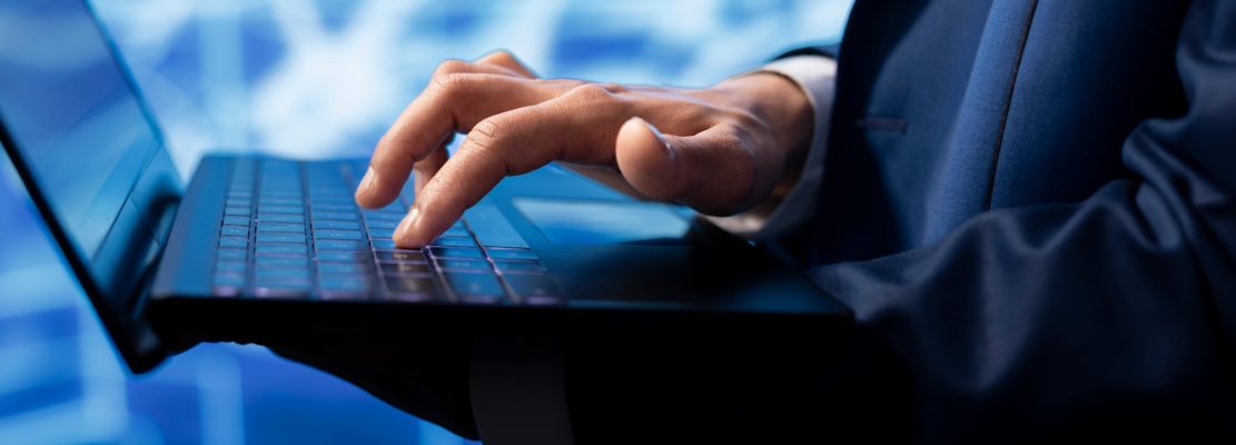 Data analyst using laptop to implement artificial intelligence, close up