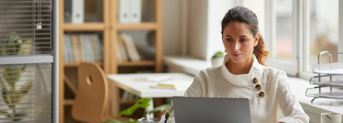 Successful Female Professional using Laptop at Home Office