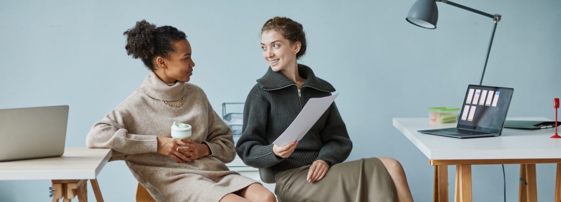 Colleagues talking during break at office