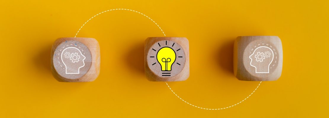 Creative idea and innovation concept. Wooden blocks with lightbulb and human head