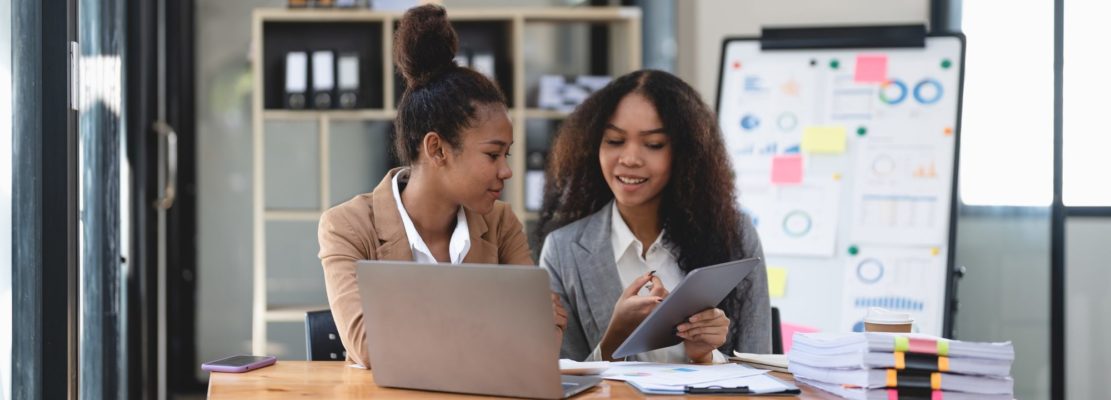Two young business people working together in office. financial analysis accounting concept.