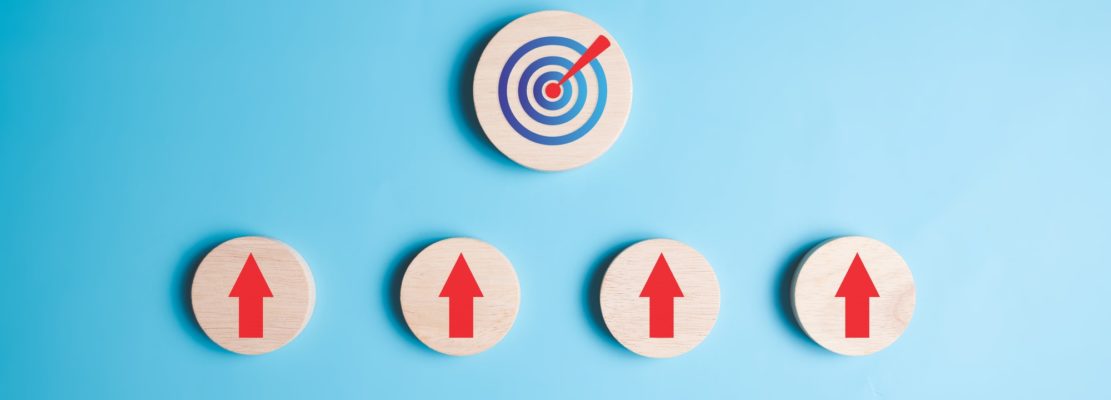 Target goal and arrow up sign on wooden blocks
