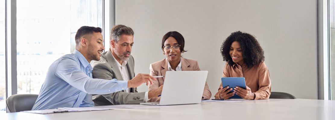 Diverse business team workers leaders group using laptop at office work meeting.