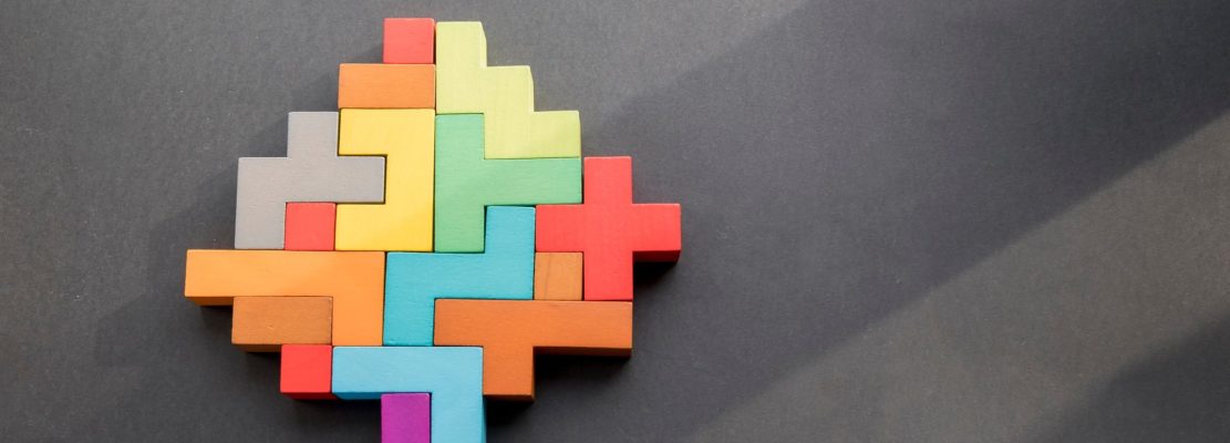 human brain wooden blocks on black background. human Geometric shapes in different colors