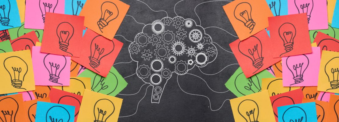 Silhouette of a brain with wheels and paper stickers with a drawn electric lamp