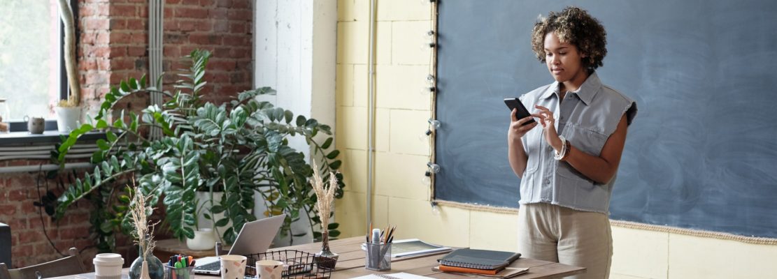 Young biracial businesswoman scrolling in smartphone