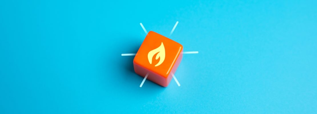 Burning flame on orange cube.