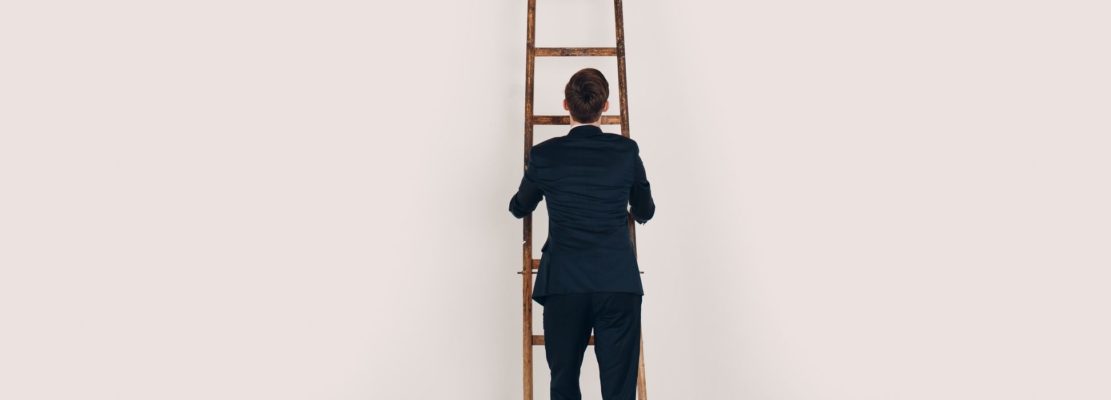 Businessman in black suit lift up the stair. Career and growth in business concept. White background