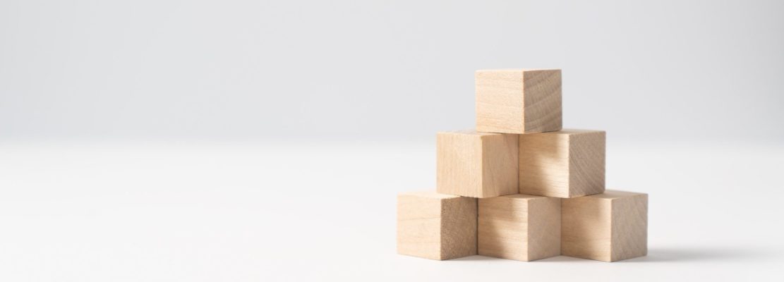 Pyramid of six wooden cubes, on white background