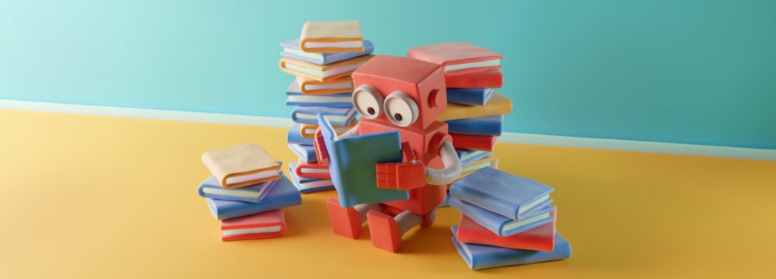 Clay robot reading a book