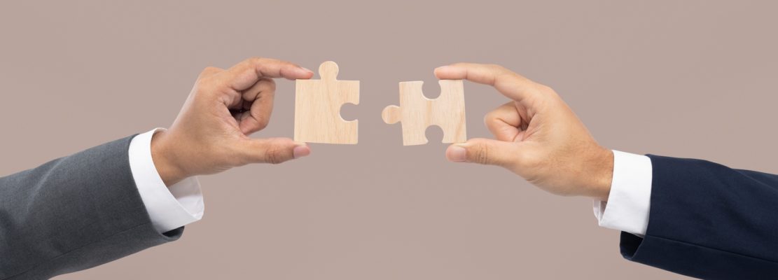 Hands holding puzzle business problem solving concept