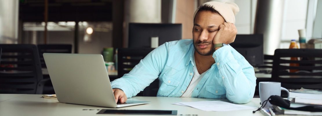 Male tired on job in the office