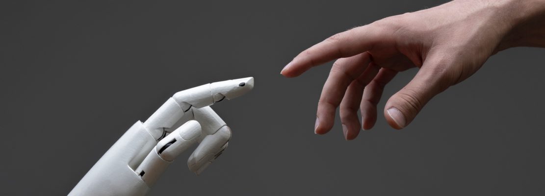 a robotic arm touching human hand, man and machine friendship