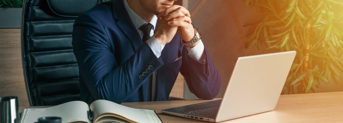 Businessman working with laptop in modern office. General manager,ceo. Young handsome confident man