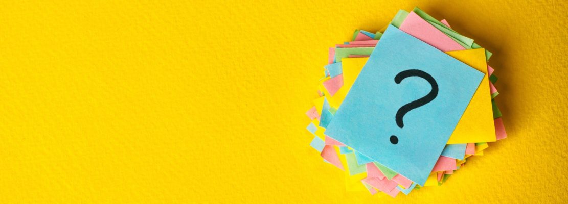 question marks written reminders tickets on yellow vintage paper background