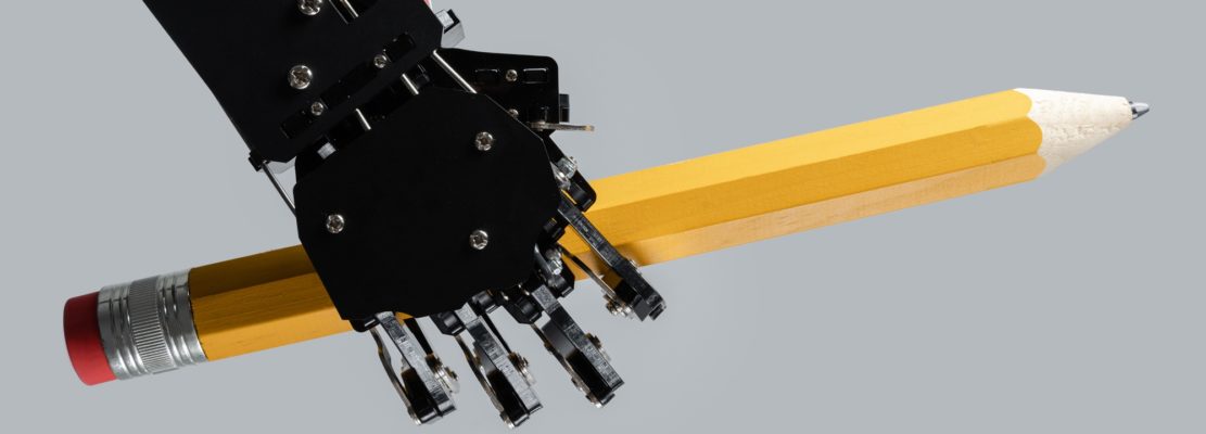 Real robotic hand with big pencil. Concept of AI-powered chatbot development