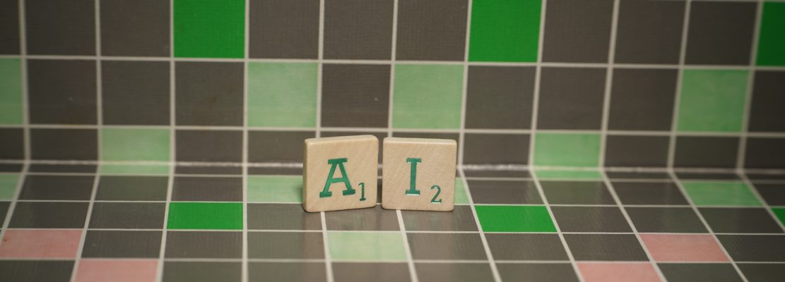 Tile with green ai text on a blocked background